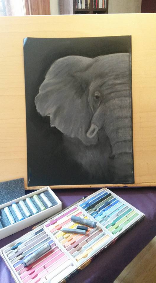 Grey and white pastel artwork of an African elephant on a black background - artwork in action
